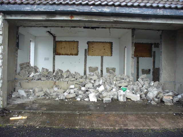 Demolition of the dividing wall between the public shelter and one of the toilets.